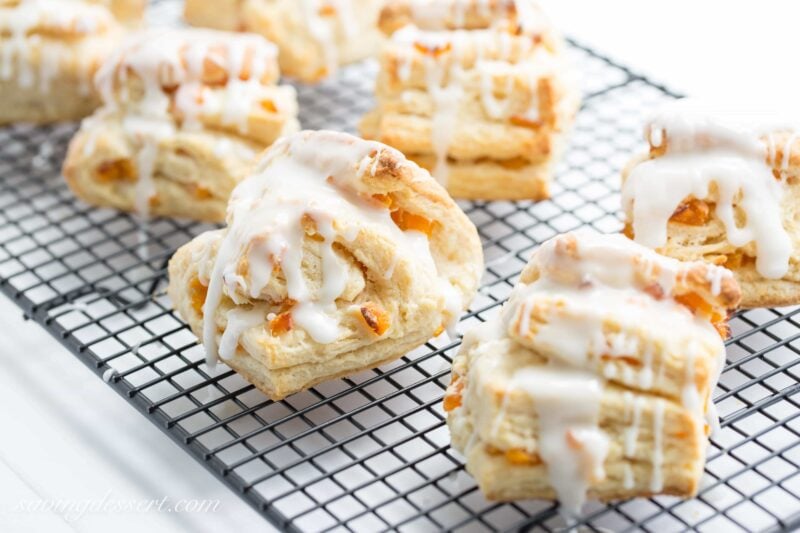 Buttery Apricot Scones ~ A light, flaky, buttery scone layered with chopped apricots and iced with an almond flavored glaze. www.savingdessert.com