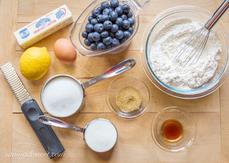 A cutting board with ingredients for a blueberry breakfast cake