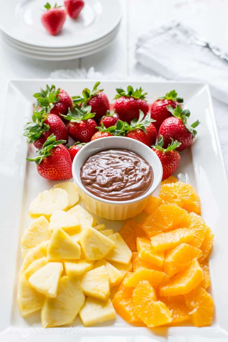 A platter of fresh fruit and a chocolate dulce de leche dip