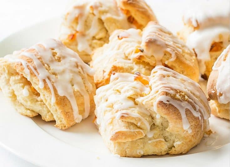 Buttery Apricot Scones ~ A light, flaky, buttery scone layered with chopped apricots and iced with an almond flavored glaze. www.savingdessert.com