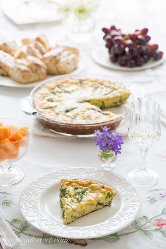 Crustless Asparagus Cheese Pie -A wonderfully easy, and cheesy pie made with eggs, asparagus, and onions. A great brunch recipe served warm or at room temperature.