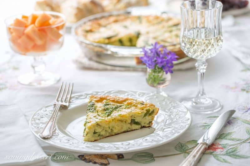 Crustless Asparagus Cheese Pie -A wonderfully easy, and cheesy pie made with eggs, asparagus, and onions. A great brunch recipe served warm or at room temperature.