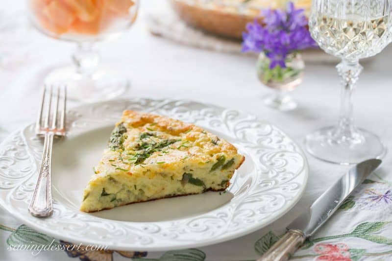 Crustless Asparagus Cheese Pie -A wonderfully easy, and cheesy pie made with eggs, asparagus, and onions. A great brunch recipe served warm or at room temperature.