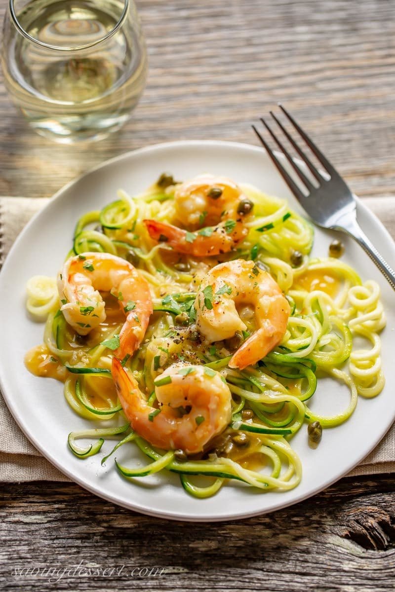 Shrimp Piccata served over zoodles with white wine