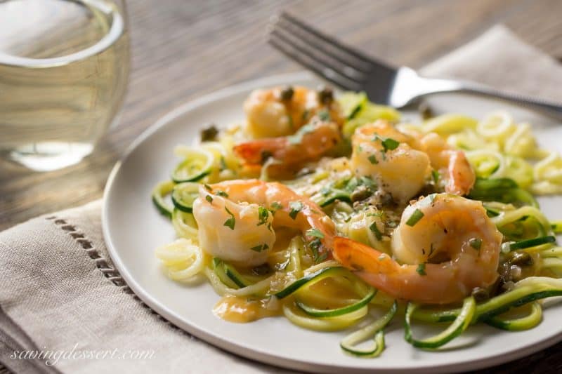 Shrimp Piccata - Zucchini noodles (zoodles) tossed with shrimp sautéed in garlic and topped with a white wine sauce. Served with capers and a squeeze of lemon ... dinner is on the table in less than 45 minutes! From Saving Room for Dessert