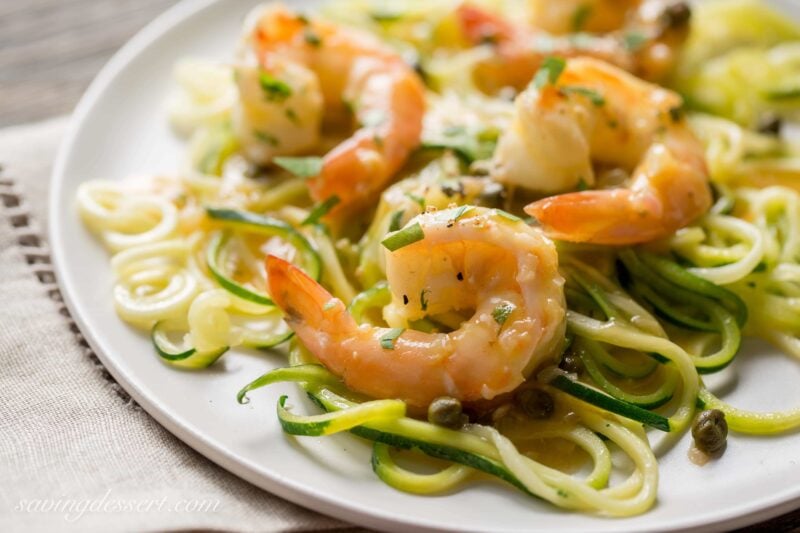 Shrimp Piccata - Zucchini noodles (zoodles) tossed with shrimp sautéed in garlic and topped with a white wine sauce. Served with capers and a squeeze of lemon ... dinner is on the table in less than 45 minutes! From Saving Room for Dessert