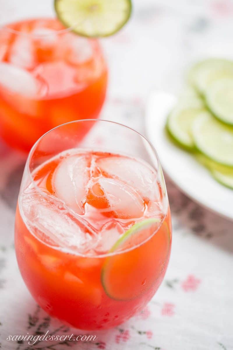 Glasses filled with strawberry agua fresca topped with slices of lime