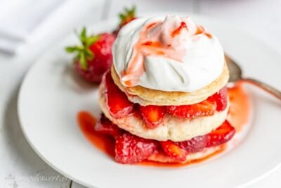 Strawberry Shortcake Scones stacked amongst fresh strawberries Strawberry Shortcake Scones
