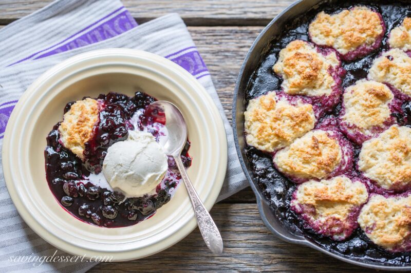 A bowl of warm cobbler topped with ice cream