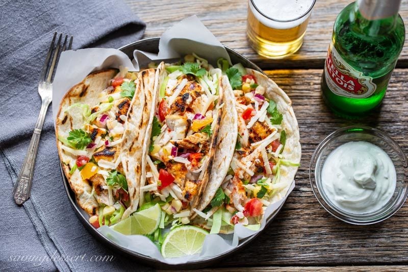 Grilled Fish tacos with cabbage, cheese, limes and corn salsa