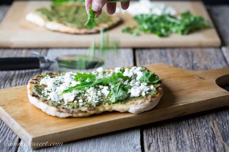 Pesto Grilled Pizza ~A full flavored pizza made with fresh Basil Pesto and peppery arugula. Feta cheese adds a nice creamy bite to this simple but tasty pizza