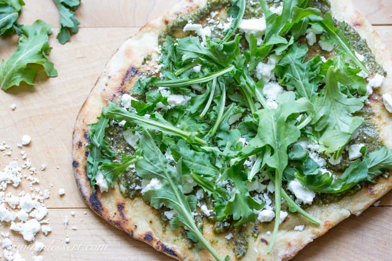 Pesto Grilled Pizza ~A full flavored pizza made with fresh Basil Pesto and peppery arugula. Feta cheese adds a nice creamy bite to this simple but tasty pizza