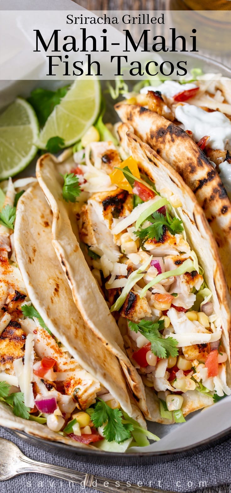 Sriracha Grilled Mahi Mahi Fish Tacos with Sweet Corn Salsa - spicy, flaky, mild Mahi Mahi piled on grilled tortillas with cabbage, cheese, and sour cream! #fishtacos #tacotuesday #taco #sriracha #grilleddtacos #sweetcornsalsa #cornsalsa