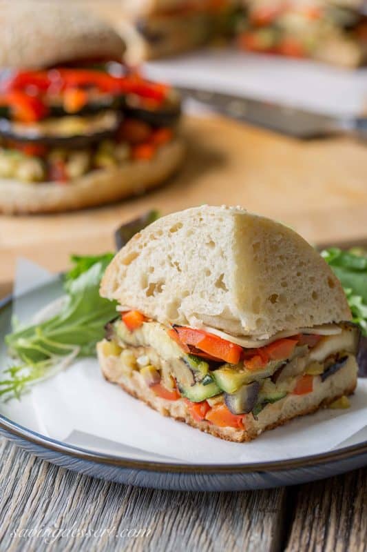 Vege Muffalettas - a vegetarian version of the popular sandwich.  Grilled fresh vegetables, provolone cheese and an olive salad piled on a homemade muffuletta loaf | www.savingdessert.com