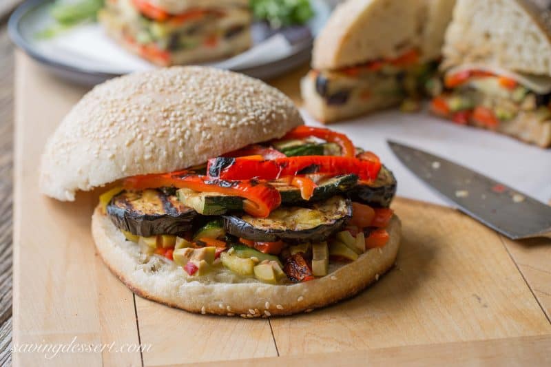 Vege Muffalettas - a vegetarian version of the popular sandwich. Grilled fresh vegetables, provolone cheese and an olive salad piled on a homemade muffuletta loaf | www.savingdessert.com