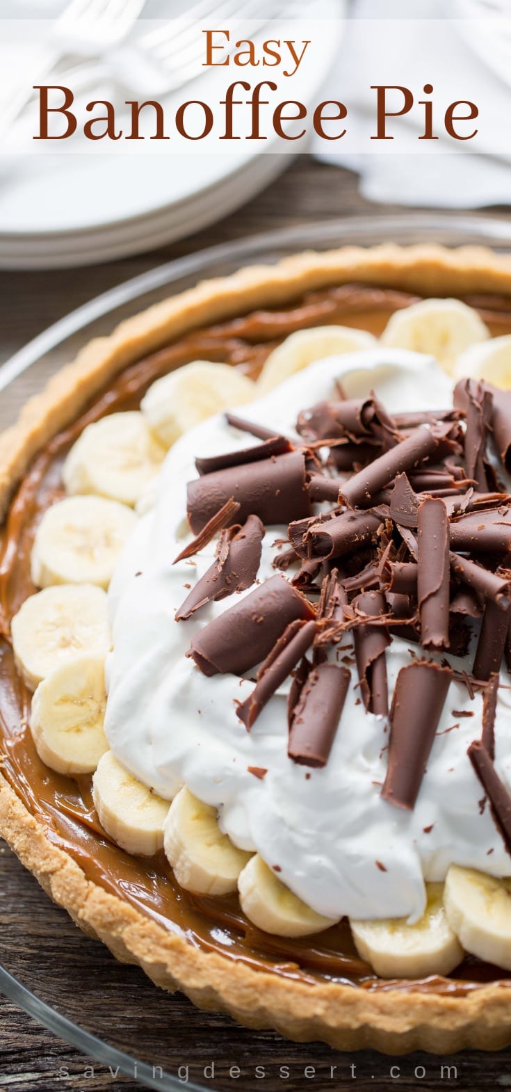 Banoffee Pie topped with whipped cream, bananas and chocolate curls