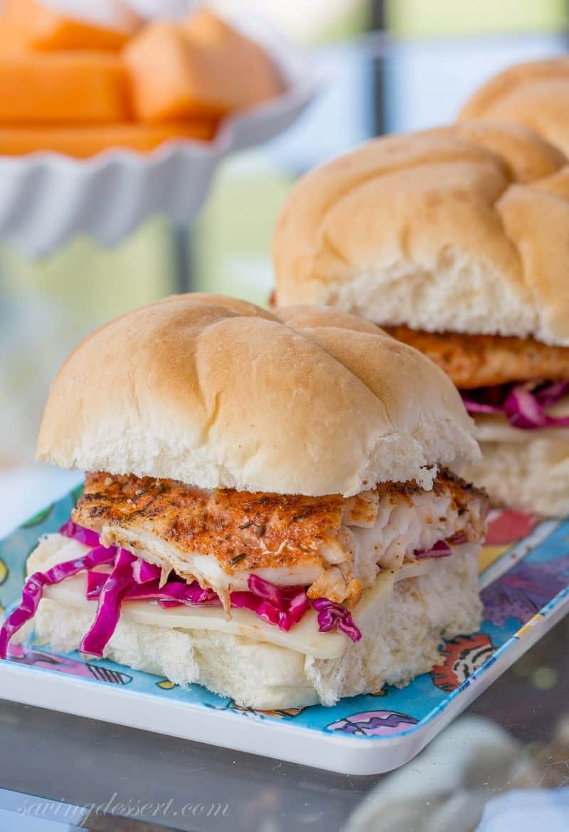 Grilled Grouper sandwiches with purple slaw on a platter