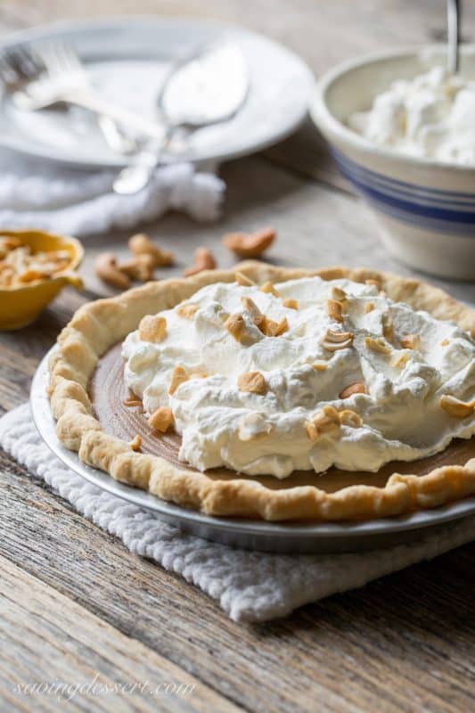 Butterscotch Pie ~ Old fashioned butterscotch custard served in a pre-baked pie crust then topped with sweetened whipped cream and chopped roasted cashews. www.savingdessert.com