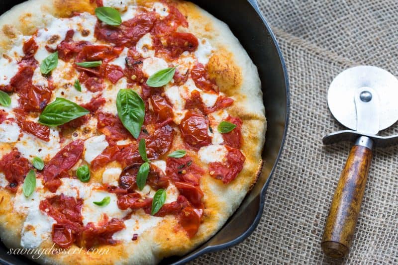 A Margherita pizza in a cast iron skillet