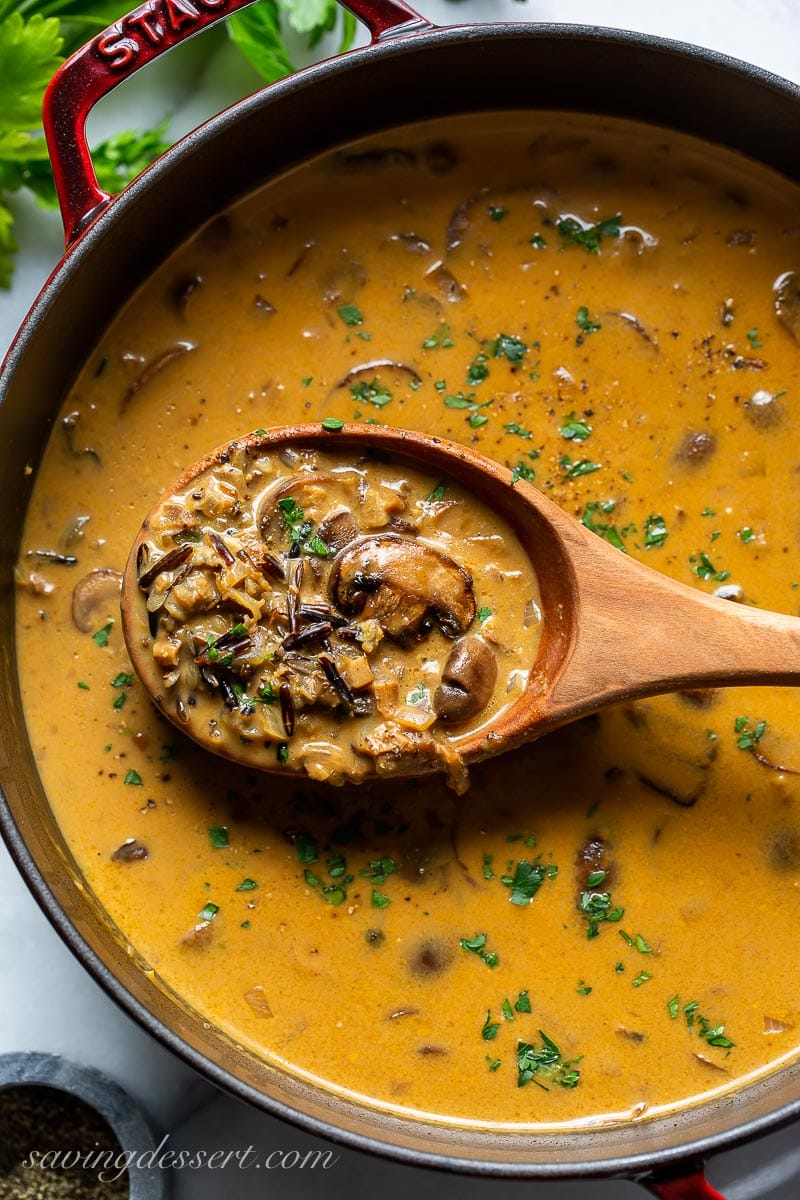 A soup pot filled with golden creamy mushroom soup