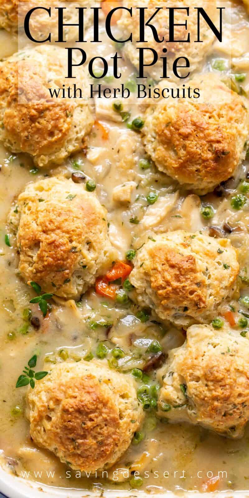 An overhead view of a casserole pan filled with chicken pot pie filling with herb filled biscuits on top