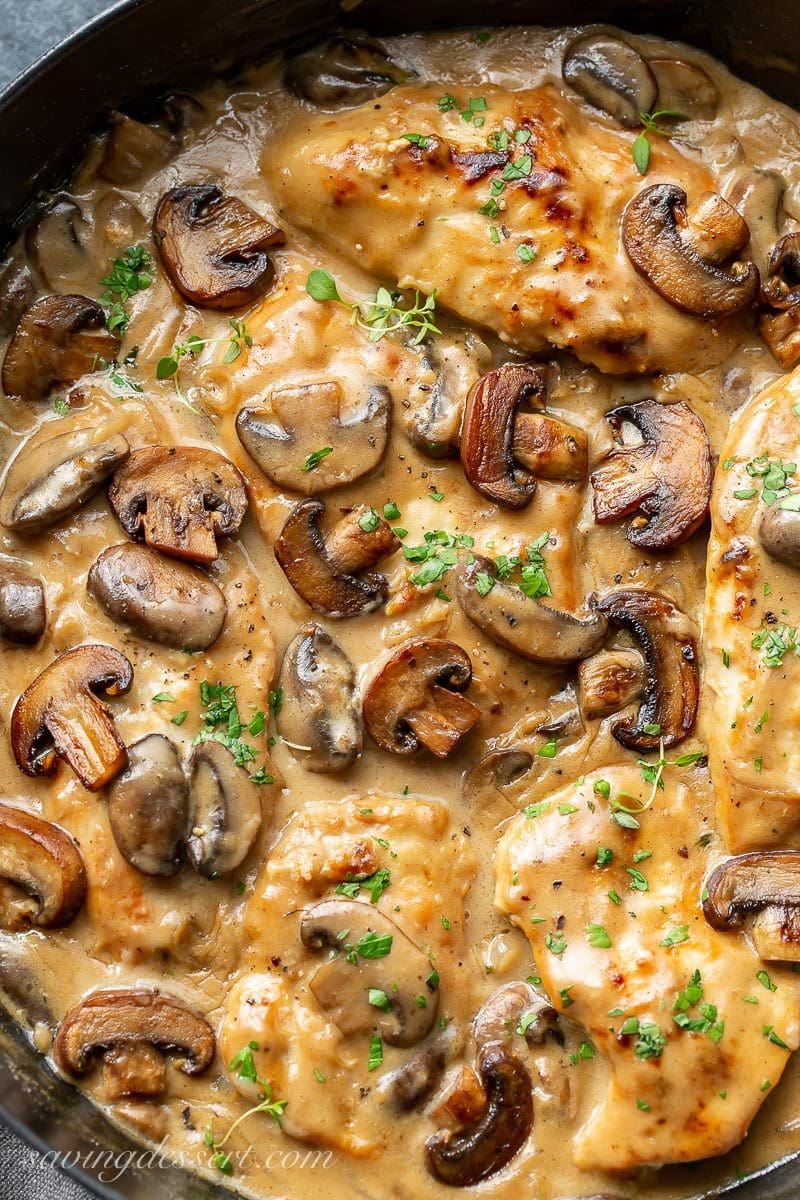 A close up of Skillet Chicken in Mushroom Wine Sauce with fresh thyme