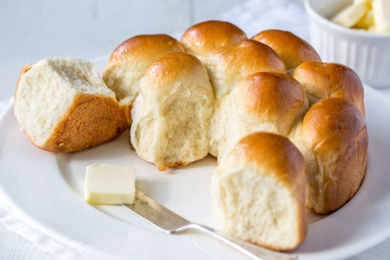 A plate of homemade rolls with butter