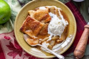 a plate of apple dessert topped with ice cream