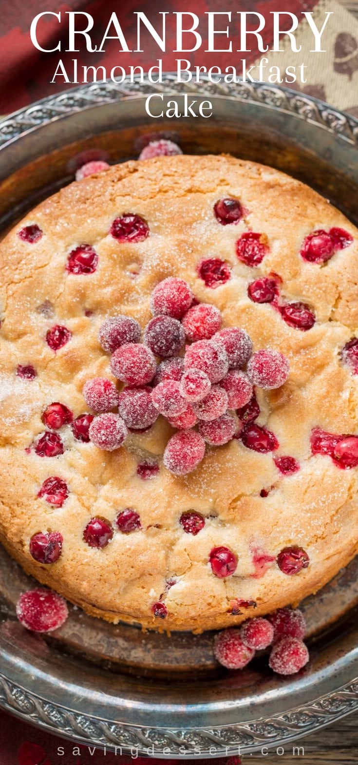 An overhead view of a cranberry almond breakfast cake topped with cranberries