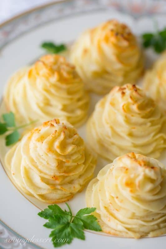 Duchess Potatoes ~ delicious mashed potatoes piped into swirls, drizzled with butter and baked to golden, puffy perfection.  So easy and pretty too! www.savingdessert.com #savingroomfordessert #potatoes #duchess #sidedish
