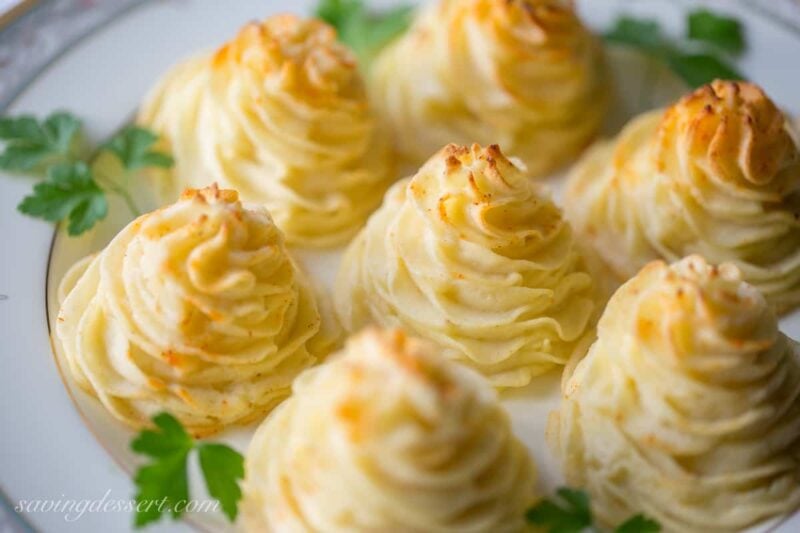 Duchess Potatoes ~ delicious mashed potatoes piped into swirls, drizzled with butter and baked to golden, puffy perfection.  So easy and pretty too! www.savingdessert.com #savingroomfordessert #potatoes #duchess #sidedish