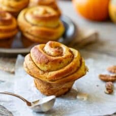A side view of a swirled pumpkin butter filled sweet roll