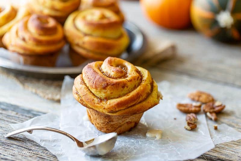 A side view of a swirled pumpkin butter filled sweet roll