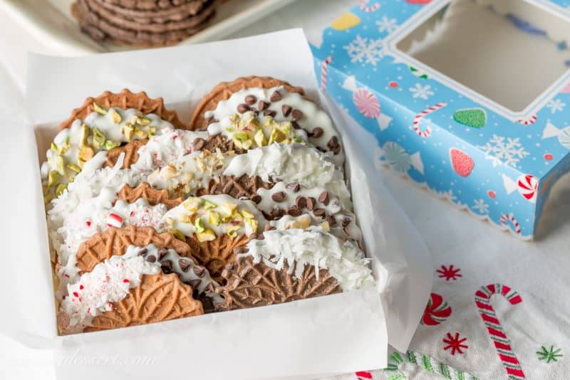 Chocolate Pizzelles dipped in white chocolate with peppermint, walnuts, chocolate chips, coconut and pistachios