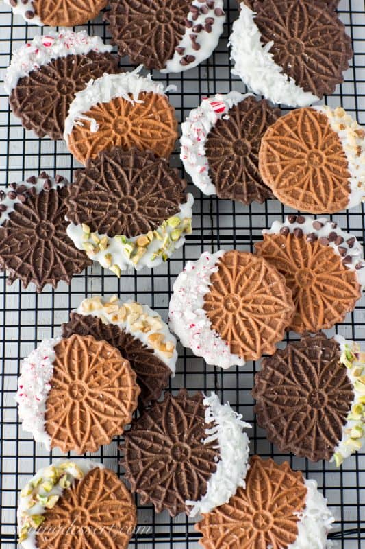 Chocolate Pizzelles dipped in white chocolate with peppermint, walnuts, chocolate chips, coconut and pistachios