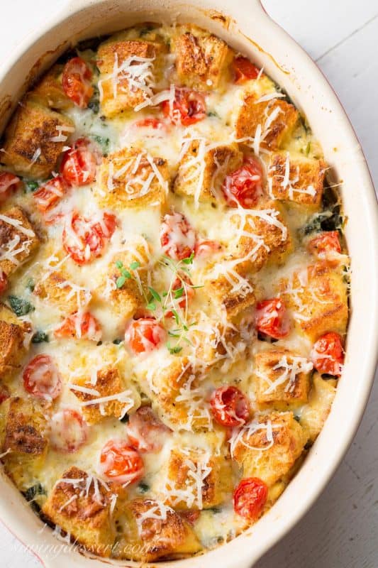 Spinach, Onion & Cheese Breakfast Strata ~ a delicious make-ahead, overnight breakfast or brunch casserole. You won't miss the meat with hearty chunks of Italian bread, ripe cherry tomatoes and rich Gruyere cheese this breakfast casserole is sure to please your hungry crowd!