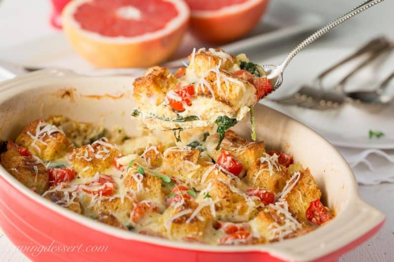 Spinach, Onion & Cheese Breakfast Strata ~ a delicious make-ahead, overnight breakfast or brunch casserole. You won't miss the meat with hearty chunks of Italian bread, ripe cherry tomatoes and rich Gruyere cheese this breakfast casserole is sure to please your hungry crowd!