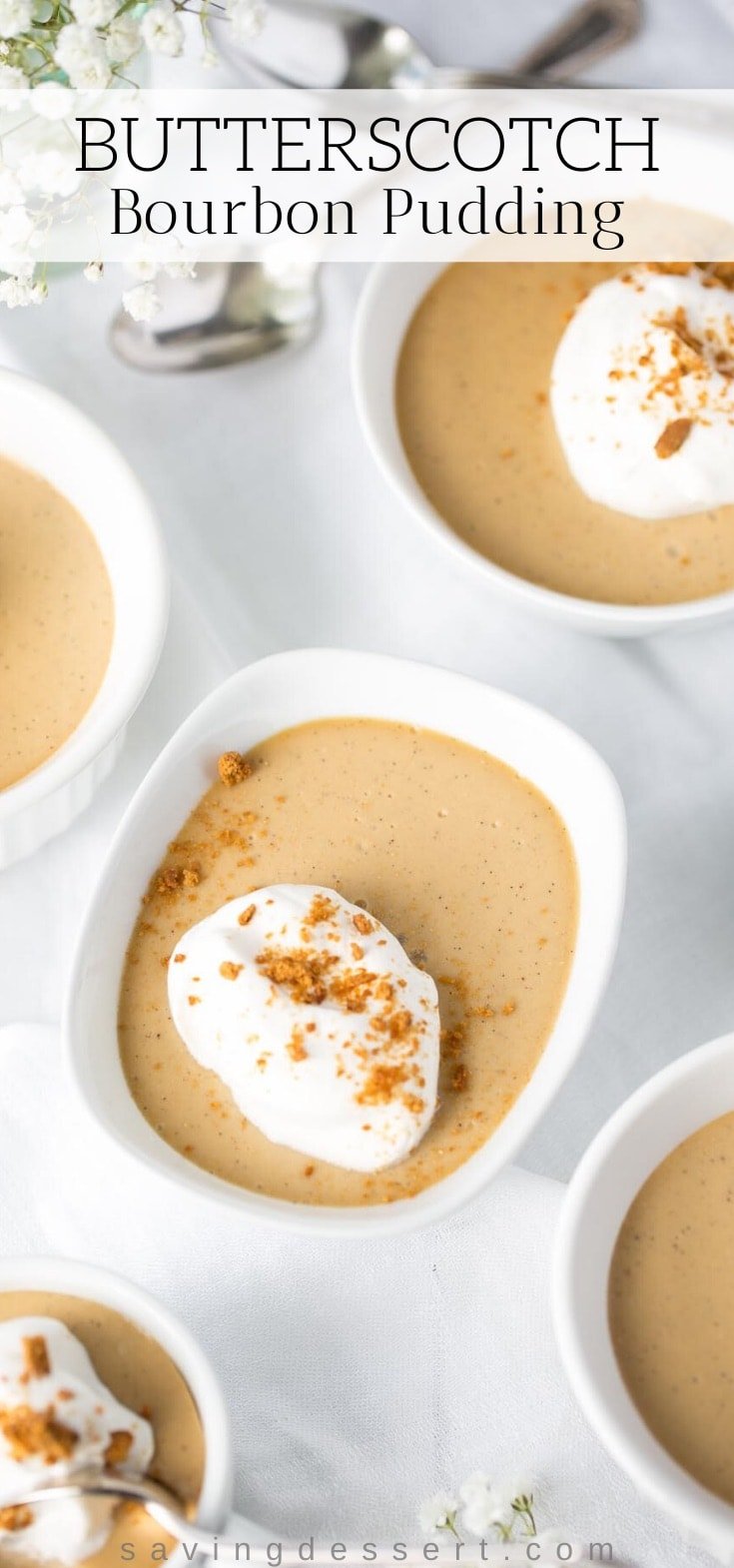 Individual bowls of butterscotch pudding topped with whipped cream and crushed gingersnaps