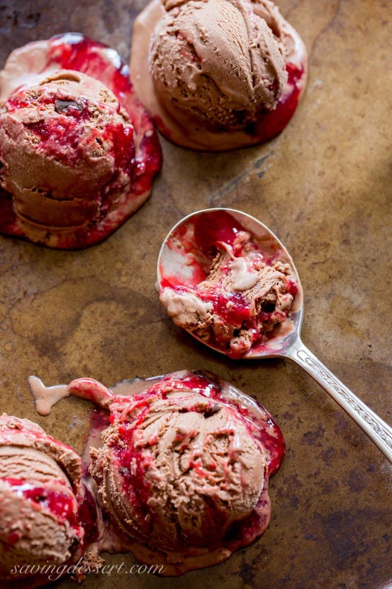 chocolate raspberry swirled ice cream in scoops on a baking pan