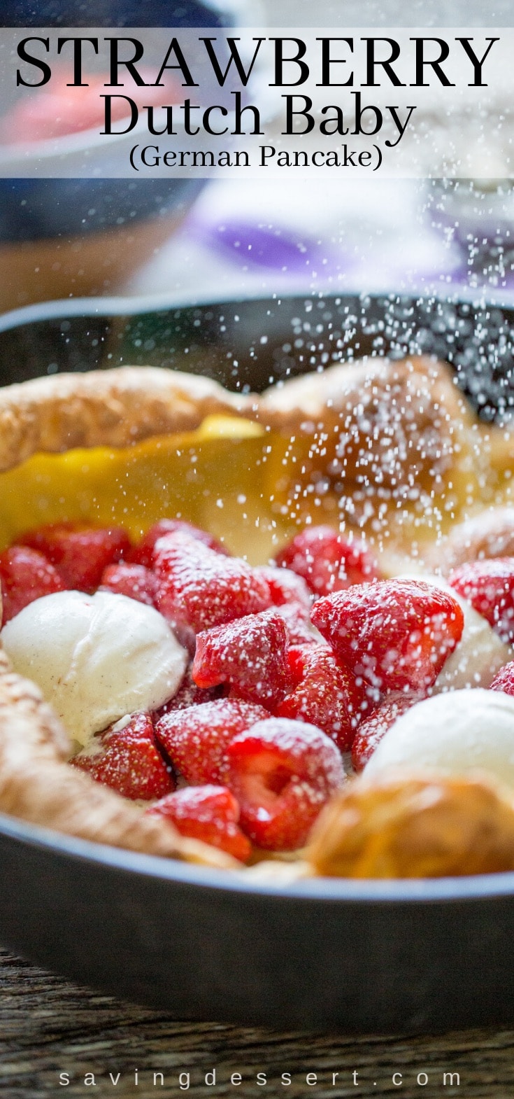 A cast iron skillet with a Dutch baby pancake filled with strawberries and ice cream