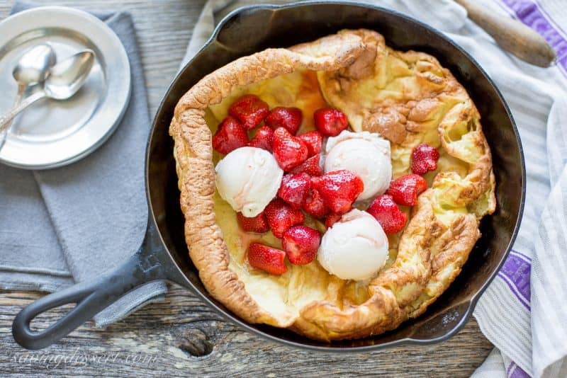 Vanilla ice cream and macerated strawberries in a Dutch Baby