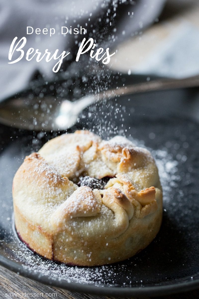 A mini pie being sprinkled with powdered sugar