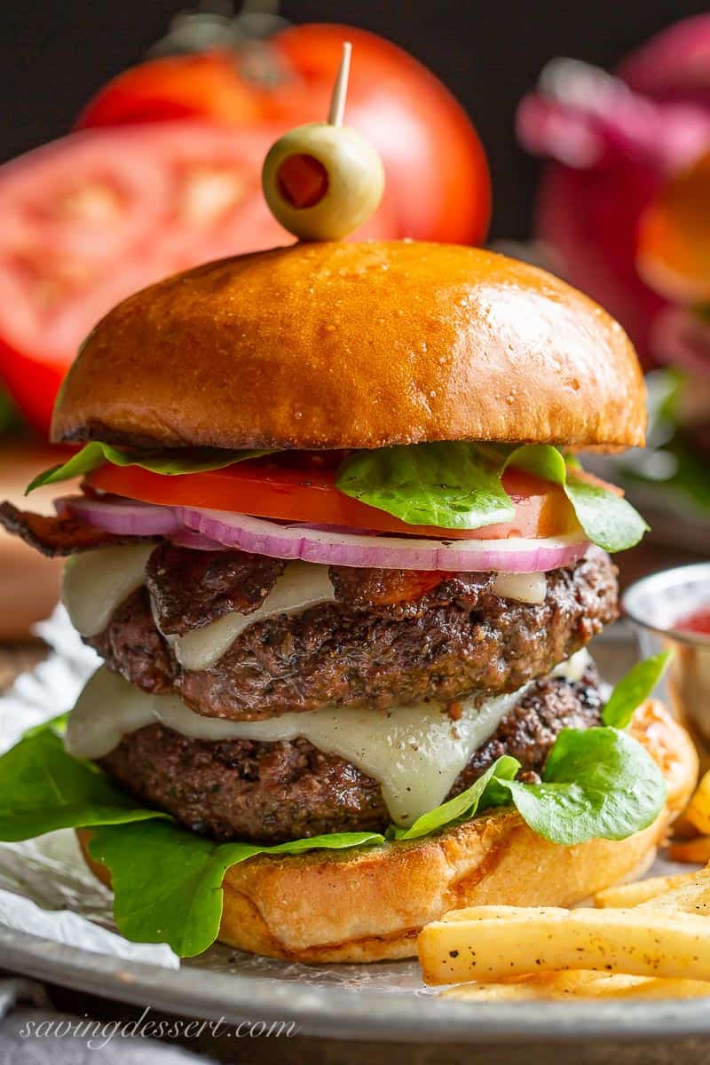 A double stacked hamburger with cheese on a bun. Served with fries on the side