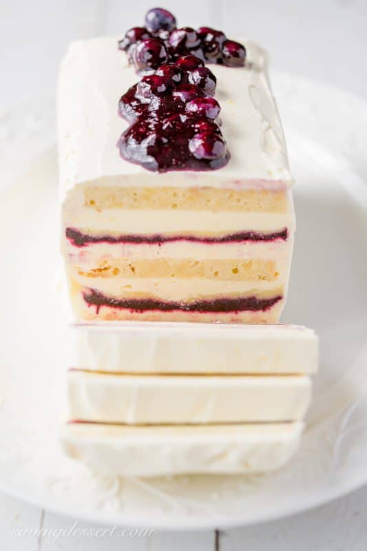 A frozen icebox cake with blueberry sauce on top