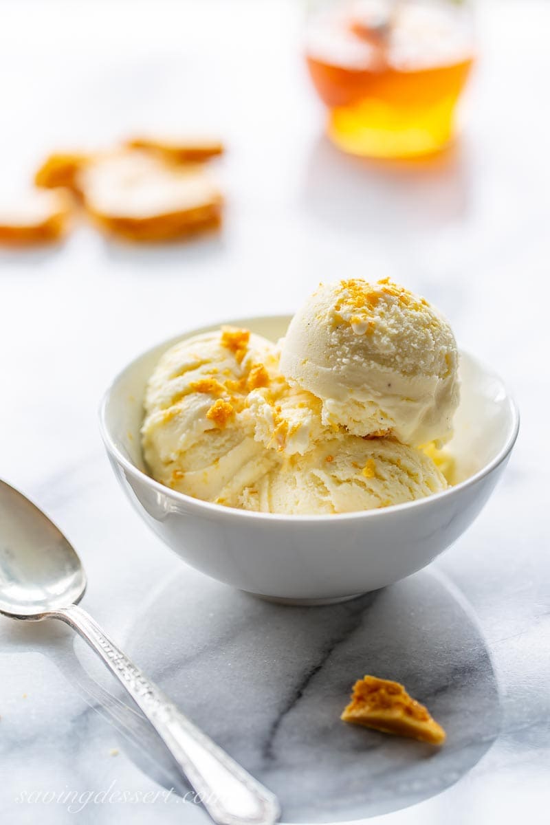 A bowl of honey ice cream sprinkled with honeycomb candy