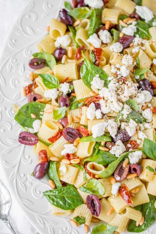 Sun Dried Tomatoes with Mezzi Rigatoni and Feta. Add fresh spinach, basil, olives and pine nuts for an amazing meatless main or hearty side!