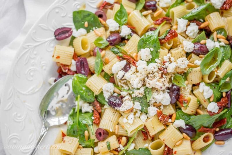 Sun Dried Tomatoes with Mezzi Rigatoni and Feta. Add fresh spinach, basil, olives and pine nuts for an amazing meatless main or hearty side!