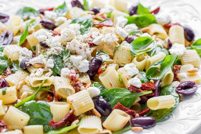 Sun Dried Tomatoes with Mezzi Rigatoni and Feta. Add fresh spinach, basil, olives and pine nuts for an amazing meatless main or hearty side!