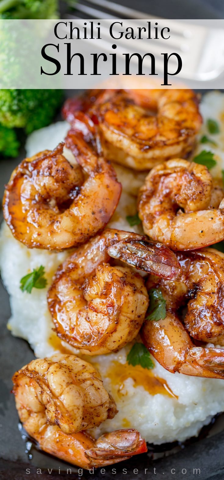 A plate of grits topped with chili garlic shrimp