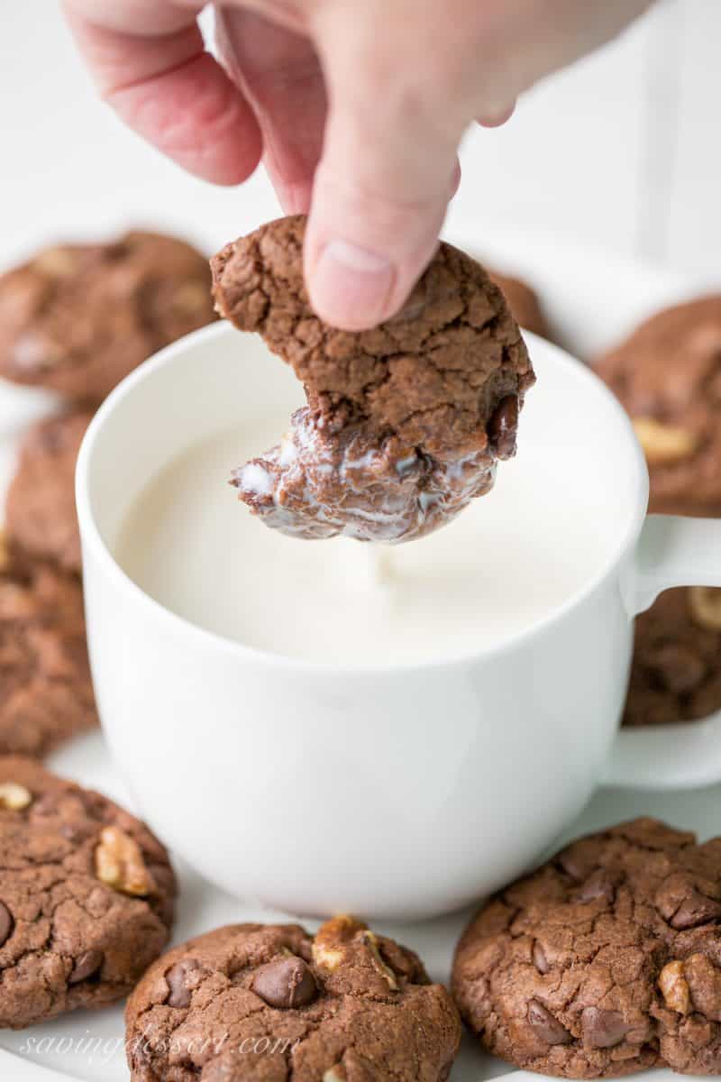 Thick and chewy Chocolate Chocolate-Chip Walnut Cookies have crispy edges, a soft almost brownie-like middle, and are loaded with big chunks of walnuts. www.savingdessert.com